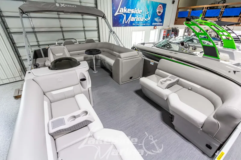 Slide: The Image of 2025 Godfrey Sweetwater 2286 FSX pontoon boat interior with plush seating at Lakeside Marina. - 13