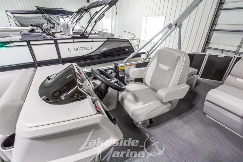 Slide: The Image of 2025 Godfrey Sweetwater 2286 FSX boat interior with steering console and seating. - 20