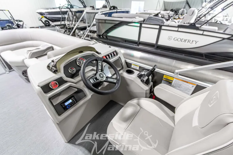 Slide: The Image of 2025 Godfrey Sweetwater 2286 FSX boat interior with steering console and seating. - 21