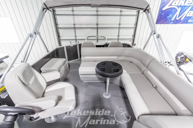 Slide: The Image of 2025 Godfrey Sweetwater 2286 FSX pontoon boat interior with gray seating and table. - 26