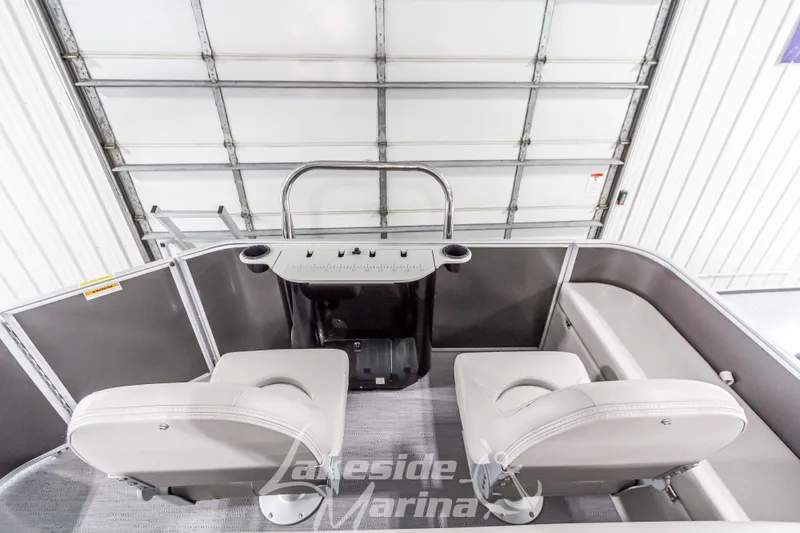 Slide: The Image of 2025 Godfrey Sweetwater 2286 FSX boat interior with dual seats in a marina setting. - 32