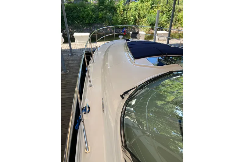 Slide: The Image of 2008 Sea Ray 44 Sundancer yacht docked, showcasing sleek design and polished deck. - 10