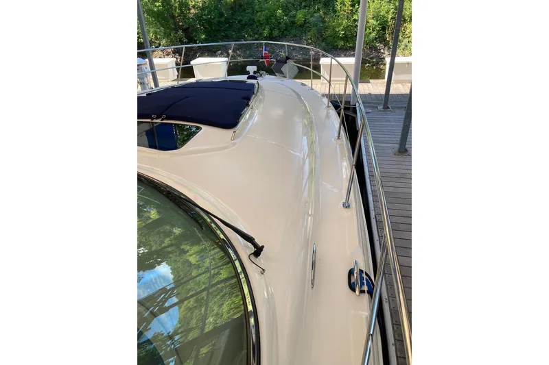 Slide: The Image of 2008 Sea Ray 44 Sundancer yacht docked, showcasing sleek design and polished deck. - 11