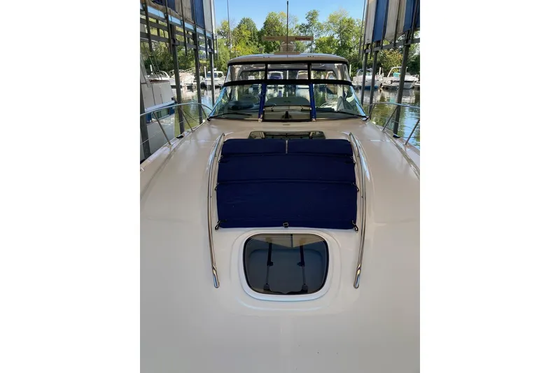 Slide: The Image of 2008 Sea Ray 44 Sundancer yacht with blue sunpad, docked in a marina. - 12