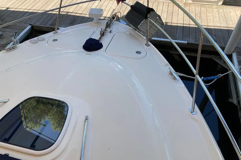 Slide: The Image of 2008 Sea Ray 44 Sundancer yacht deck with railing and hatch, docked at marina. - 14