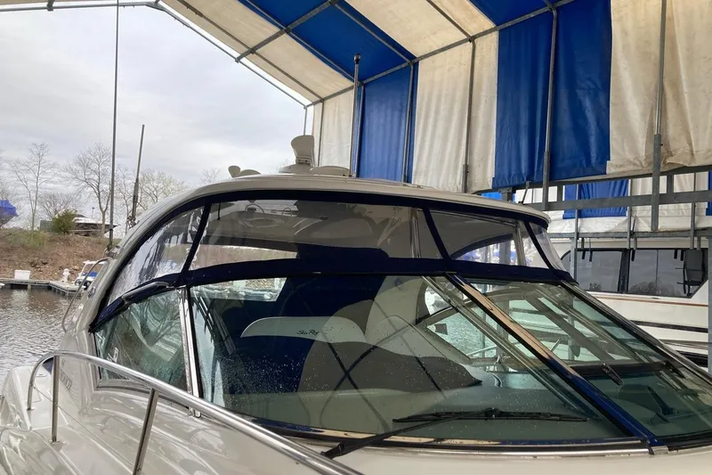 Slide: The Image of 2008 Sea Ray 44 Sundancer yacht docked under a blue and white canopy. - 15