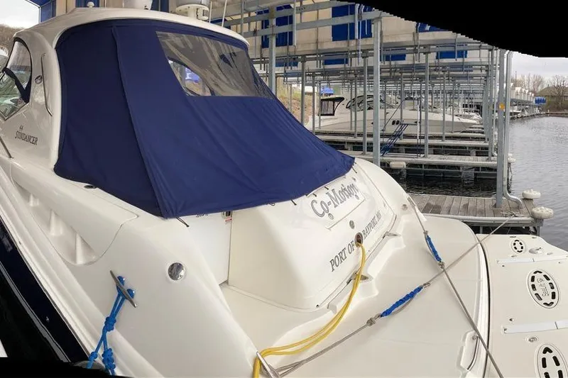 Slide: The Image of 2008 Sea Ray 44 Sundancer yacht docked with blue cover in marina. - 19