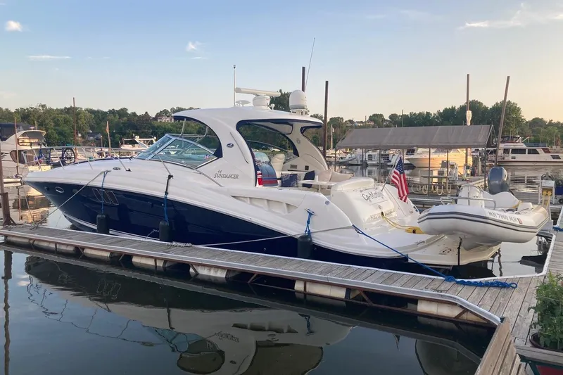 Slide: The Image of 2008 Sea Ray 44 Sundancer yacht docked at marina with inflatable boat attached. - 2