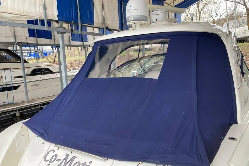 Slide: The Image of 2008 Sea Ray 44 Sundancer yacht with blue canvas cover in marina. - 20