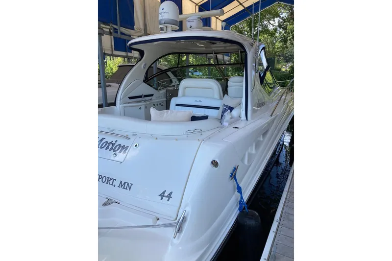 Slide: The Image of 2008 Sea Ray 44 Sundancer yacht docked, featuring sleek white design and spacious seating. - 21