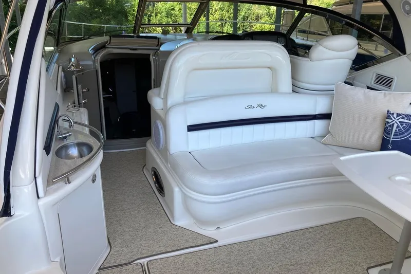 Slide: The Image of 2008 Sea Ray 44 Sundancer interior with white seating, sink, and nautical decor. - 25