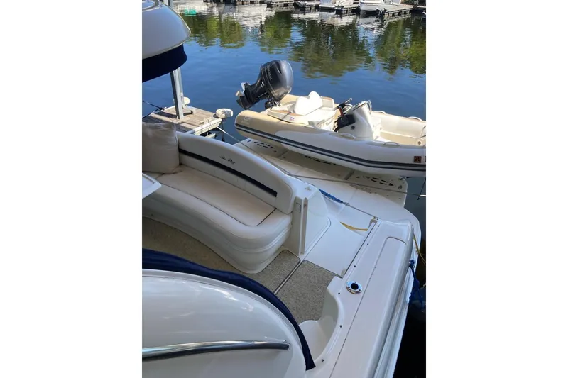 Slide: The Image of 2008 Sea Ray 44 Sundancer yacht interior with seating, docked by calm waters. - 28