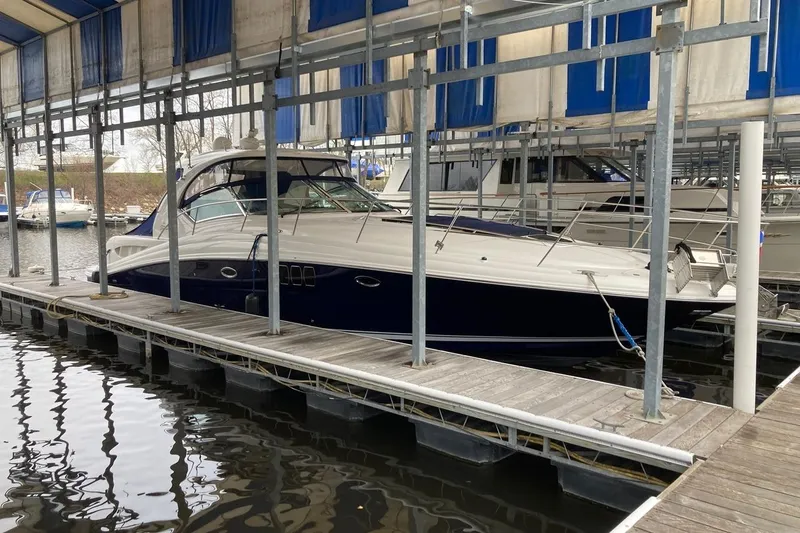 Slide: The Image of 2008 Sea Ray 44 Sundancer yacht docked in a marina under a covered slip. - 3