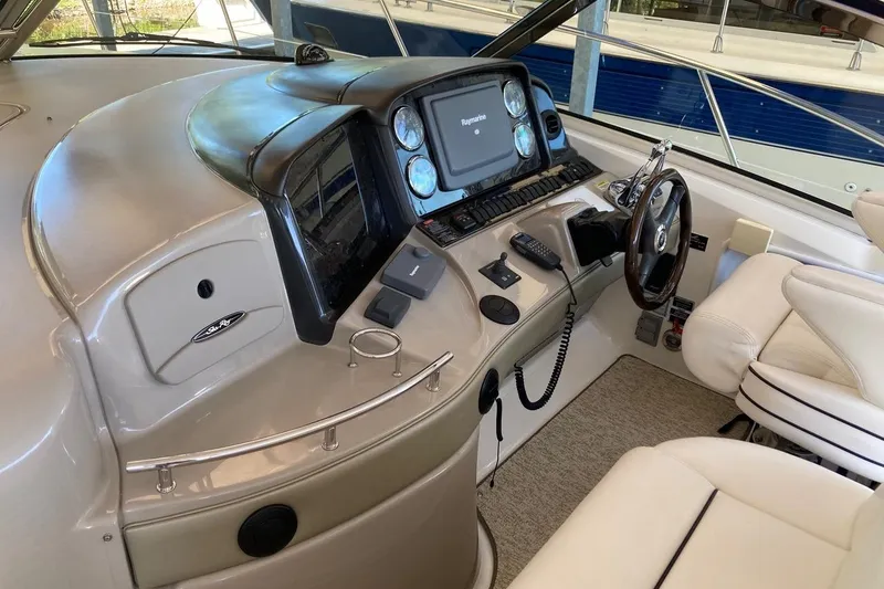 Slide: The Image of 2008 Sea Ray 44 Sundancer helm with modern navigation equipment and luxurious seating. - 31