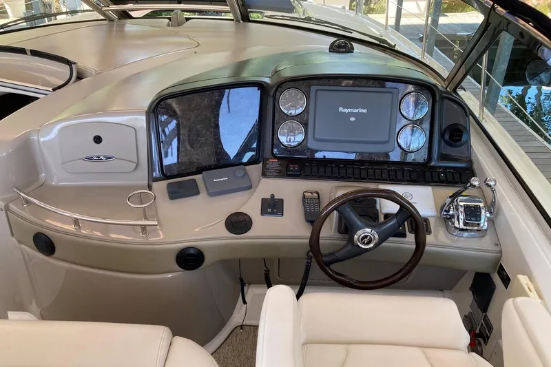 Slide: The Image of 2008 Sea Ray 44 Sundancer helm with Raymarine display and luxurious controls. - 32