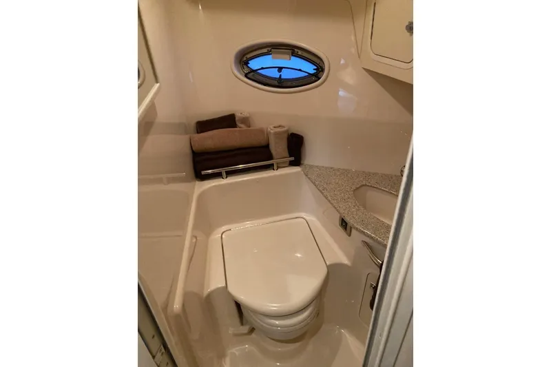 Slide: The Image of 2008 Sea Ray 44 Sundancer yacht bathroom with modern fixtures and porthole window. - 39