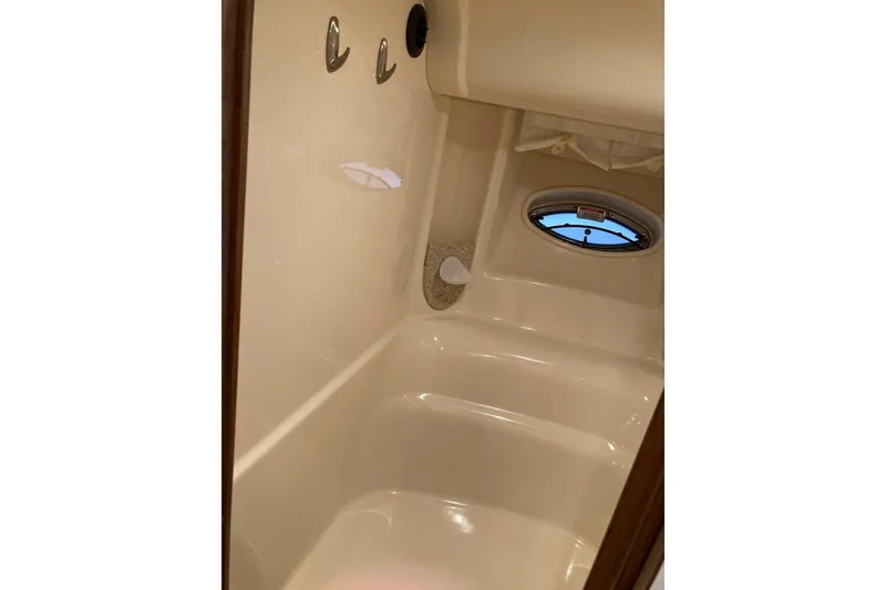 Slide: The Image of 2008 Sea Ray 44 Sundancer bathroom interior with porthole and hooks. - 41