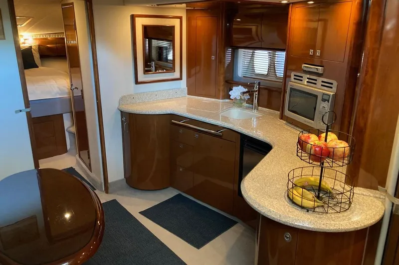 Slide: The Image of Luxurious 2008 Sea Ray 44 Sundancer yacht interior with modern kitchen and cozy bedroom. - 42