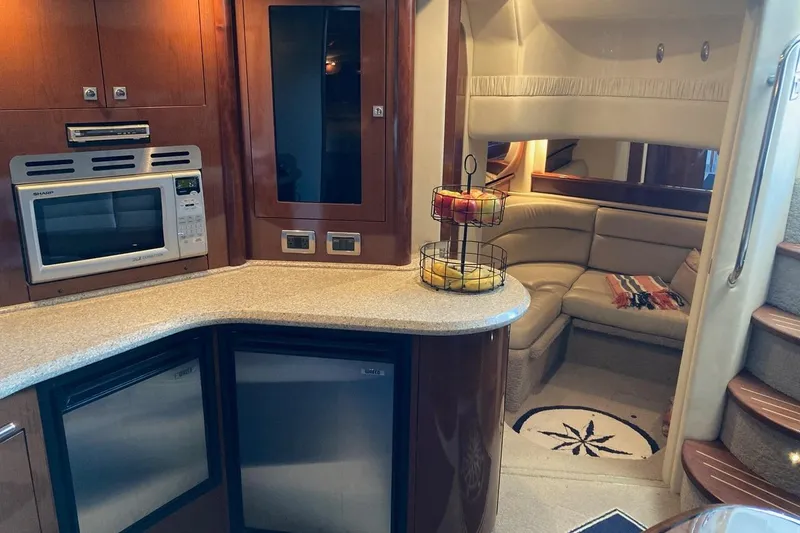 Slide: The Image of Luxurious 2008 Sea Ray 44 Sundancer yacht interior with modern kitchen and cozy seating area. - 43