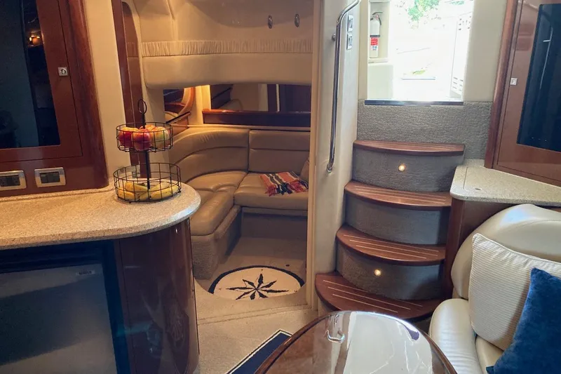 Slide: The Image of Luxurious interior of 2008 Sea Ray 44 Sundancer yacht with elegant seating and wooden stairs. - 44