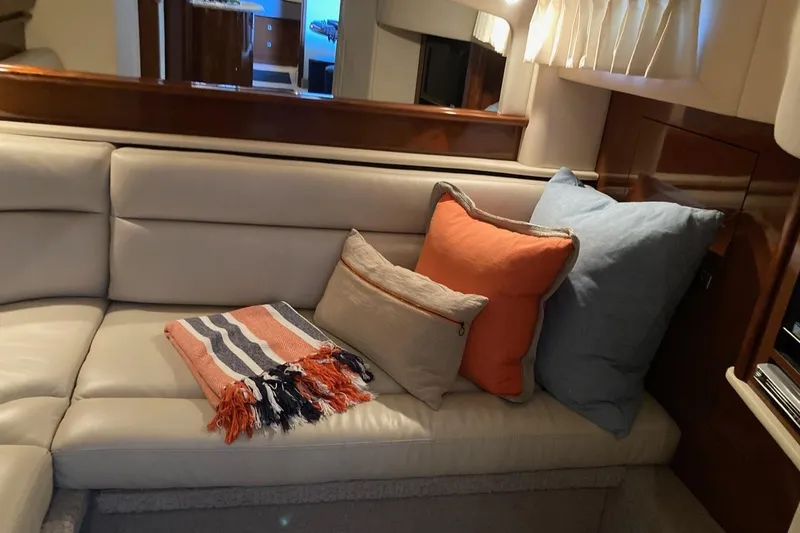 Slide: The Image of Luxurious interior of 2008 Sea Ray 44 Sundancer with plush cushions and cozy blanket. - 48