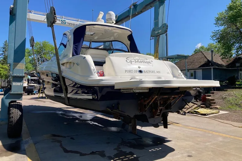 Slide: The Image of 2008 Sea Ray 44 Sundancer yacht on lift, sunny day, marina setting. - 52