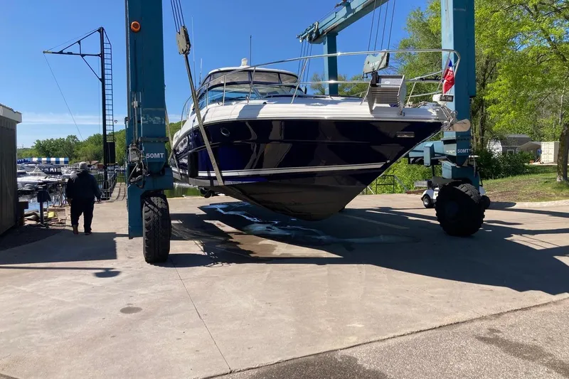 Slide: The Image of 2008 Sea Ray 44 Sundancer yacht lifted by crane at marina. - 54