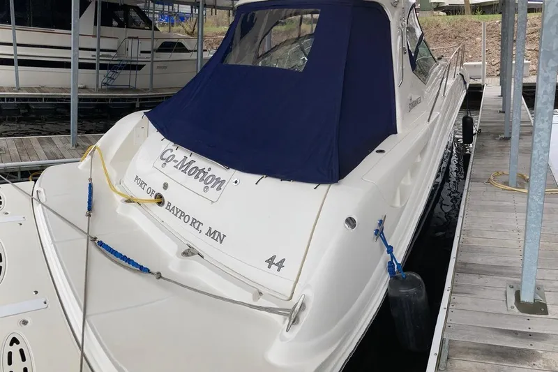 Slide: The Image of 2008 Sea Ray 44 Sundancer docked, featuring a blue cover and "Co-Motion" nameplate. - 8
