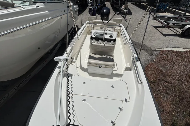 Slide: The Image of 2021 Boston Whaler 170 Montauk boat, top view, docked beside another vessel. - 2