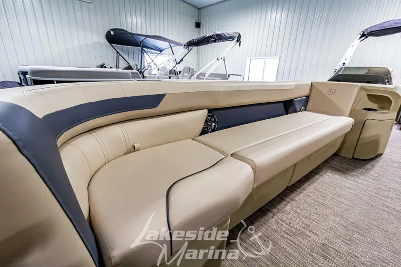 Slide: The Image of 2025 Godfrey Sweetwater 2286 C pontoon boat interior with beige seating at Lakeside Marina. - 12