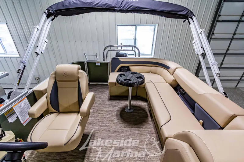 Slide: The Image of 2025 Godfrey Sweetwater 2286 C pontoon boat interior with beige seating and table. - 17