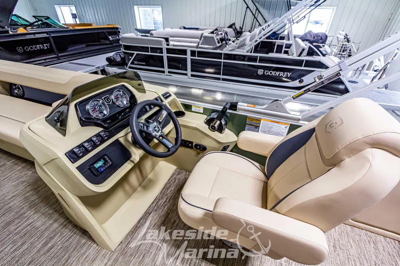 Slide: The Image of 2025 Godfrey Sweetwater 2286 C boat interior with steering console and seating. - 18