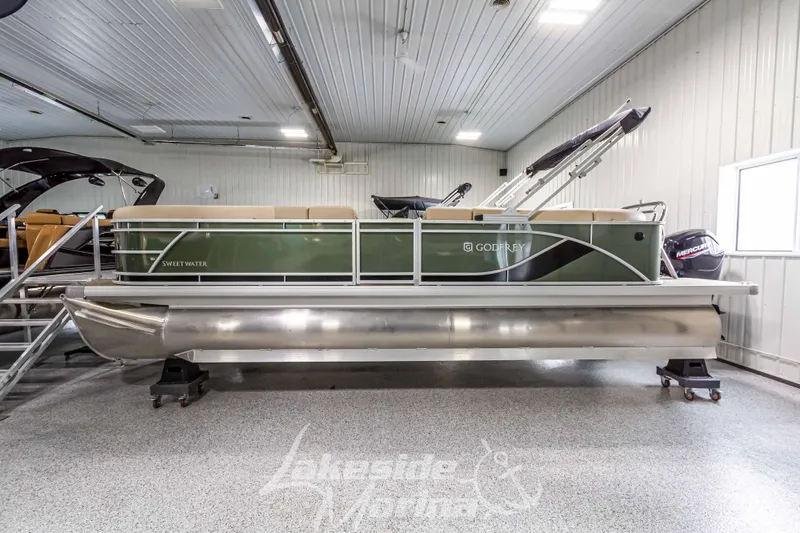 Slide: The Image of 2025 Godfrey Sweetwater 2286 C pontoon boat in indoor showroom. - 2