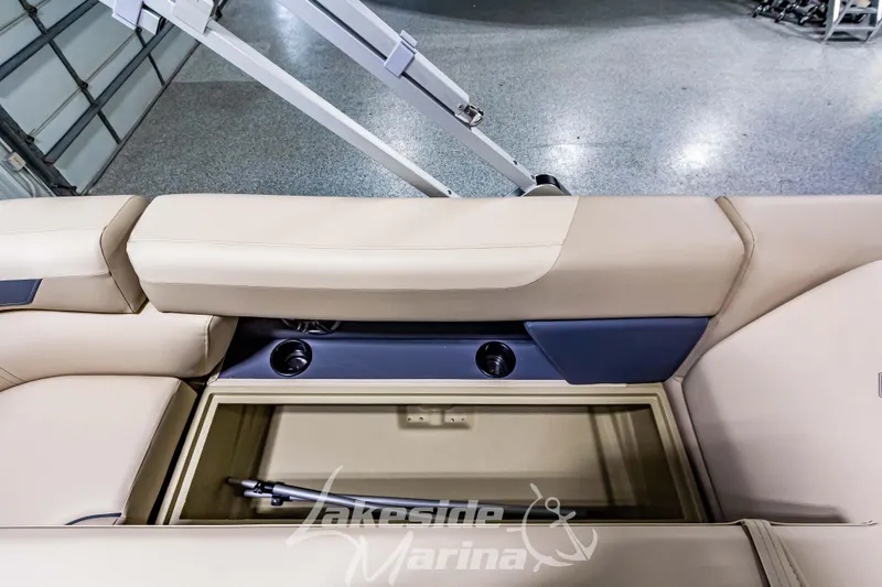 Slide: The Image of 2025 Godfrey Sweetwater 2286 C boat interior with storage compartment and cup holders. - 24