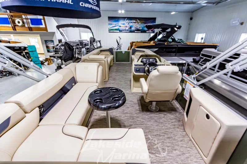 Slide: The Image of 2025 Godfrey Sweetwater 2286 C pontoon boat interior with beige seating and modern dashboard. - 29