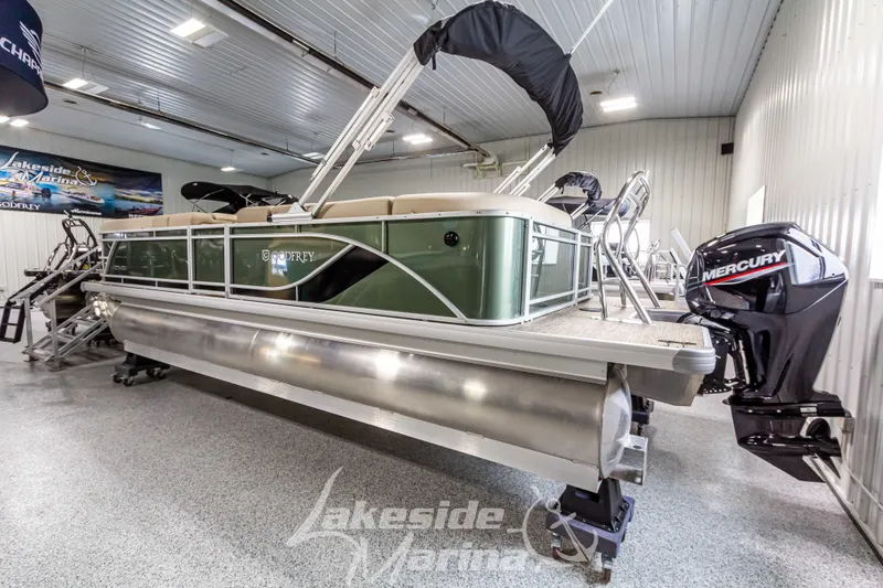 Slide: The Image of 2025 Godfrey Sweetwater 2286 C pontoon boat in showroom with Mercury outboard. - 3