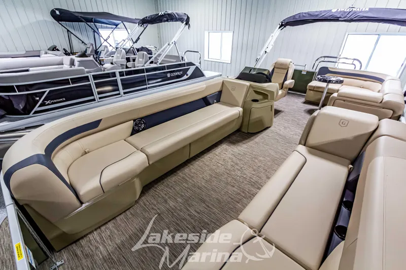 Slide: The Image of 2025 Godfrey Sweetwater 2286 C pontoon boat interior with beige seating at Lakeside Marina. - 8