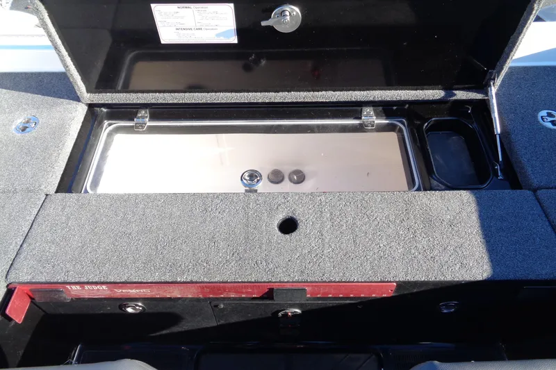 Slide: The Image of Open storage compartment in 2021 Vexus DVX20 boat, featuring carpeted interior and metal hinges. - 32