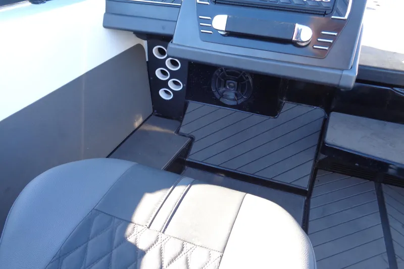 Slide: The Image of 2021 Vexus DVX20 boat interior with black seating and dashboard details. - 39