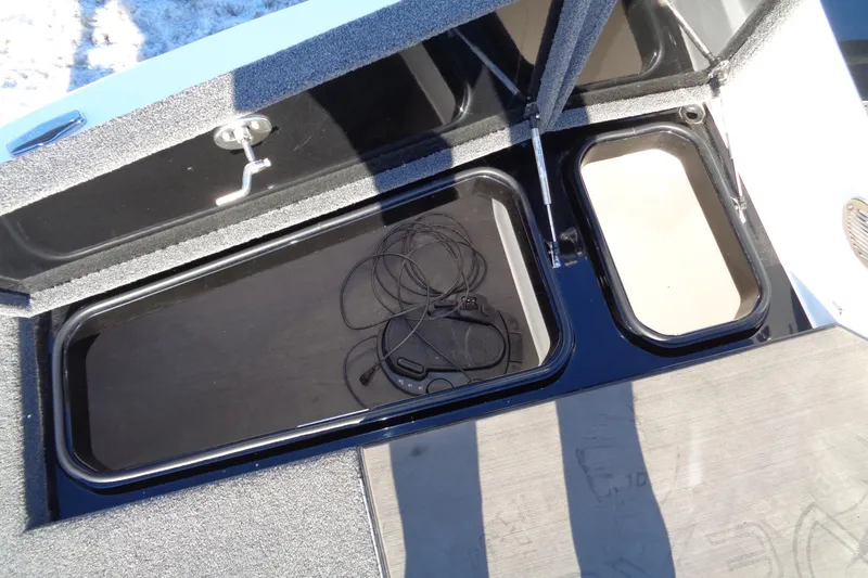 Slide: The Image of Open storage compartments on a 2021 Vexus DVX20 boat, showing cables inside. - 47