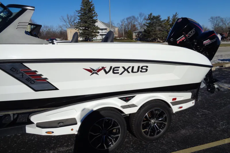 Slide: The Image of 2021 Vexus DVX20 boat on trailer, featuring sleek design and powerful engine. - 5