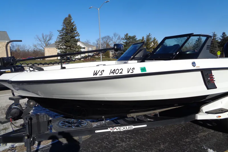 Slide: The Image of 2021 Vexus DVX20 boat on trailer, white exterior, parked outdoors on a sunny day. - 6