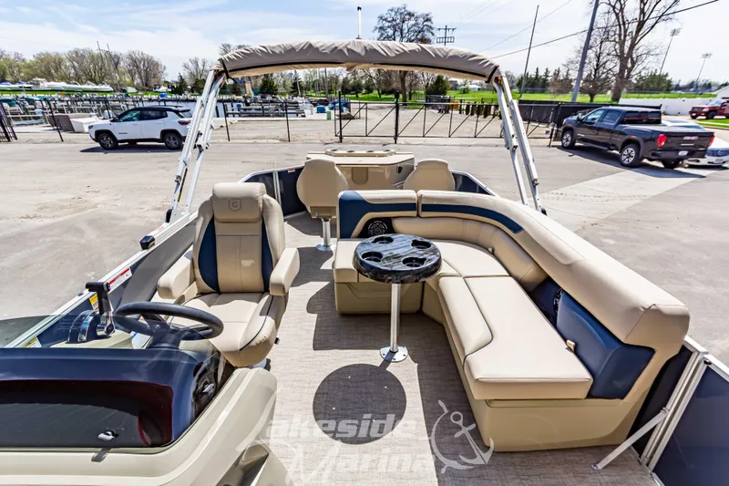 Slide: The Image of 2025 Godfrey Sweetwater 2286 FSX pontoon boat interior with beige seating and steering console. - 18