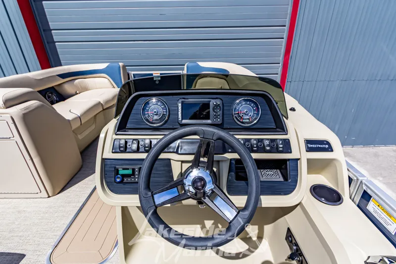 Slide: The Image of 2025 Godfrey Sweetwater 2286 FSX boat dashboard with steering wheel and gauges. - 20