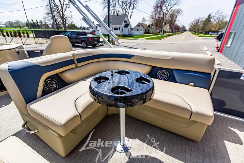 Slide: The Image of 2025 Godfrey Sweetwater 2286 FSX boat interior with plush seating and cupholder table. - 24