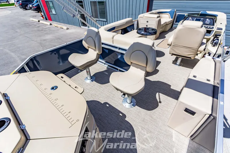 Slide: The Image of 2025 Godfrey Sweetwater 2286 FSX pontoon boat interior with beige seating and helm. - 28