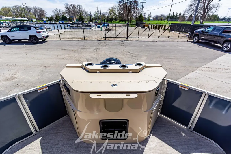 Slide: The Image of 2025 Godfrey Sweetwater 2286 FSX boat at Lakeside Marina, docked with vehicles nearby. - 29