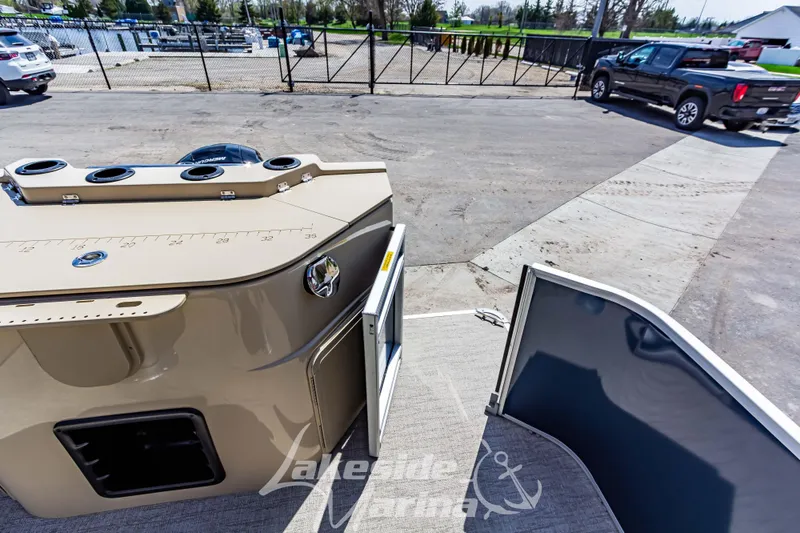 Slide: The Image of 2025 Godfrey Sweetwater 2286 FSX boat at marina, featuring deck and storage area. - 35