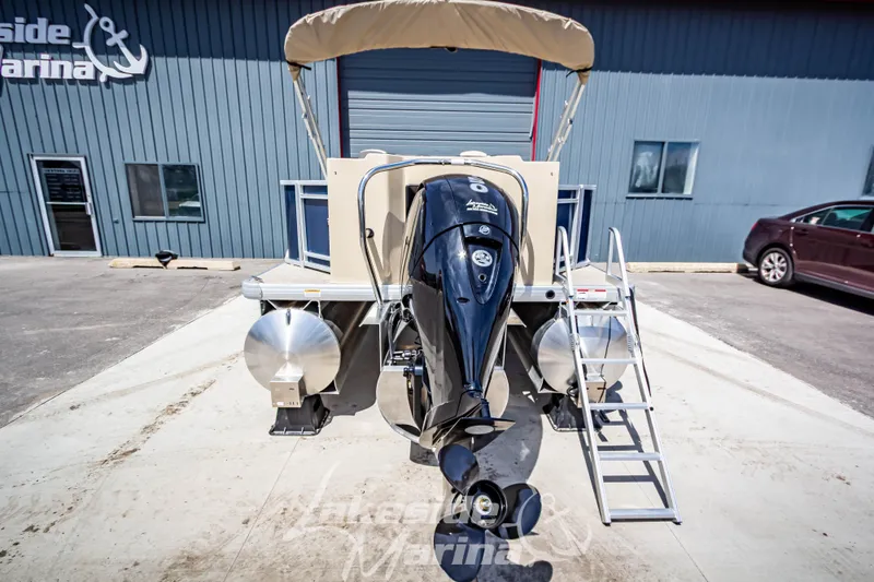 Slide: The Image of 2025 Godfrey Sweetwater 2286 FSX pontoon boat with outboard motor at marina. - 5