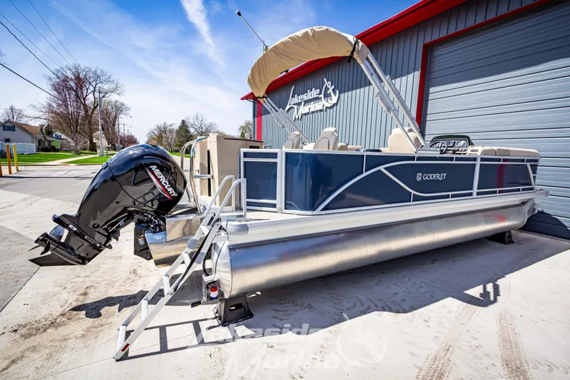 Slide: The Image of 2025 Godfrey Sweetwater 2286 FSX pontoon boat with Mercury outboard, parked at Lakeside Marina. - 7